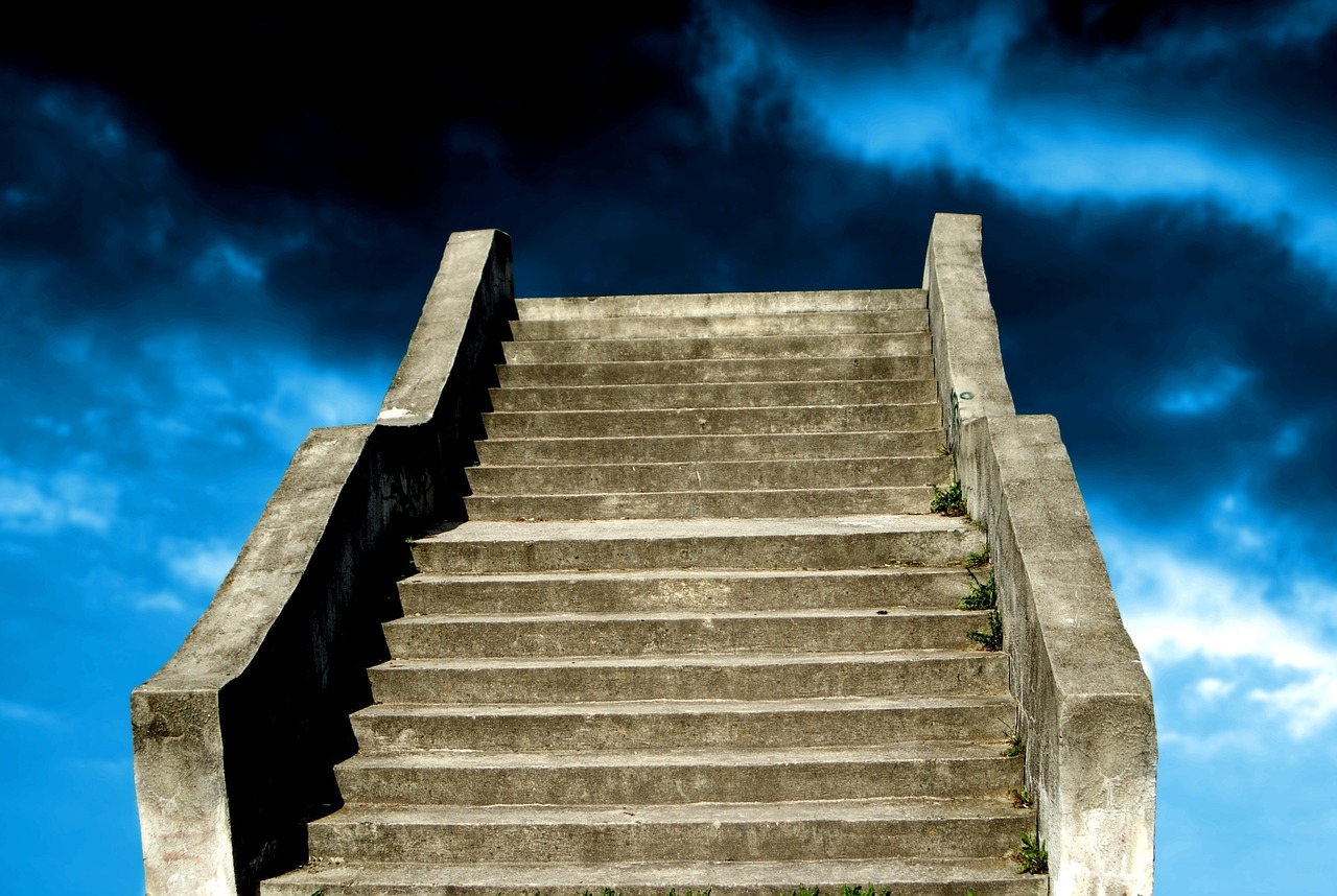 a man riding a skateboard up the side of a flight of stairs, by Edward Corbett, flickr, with dark clouds in the sky, old stone steps, stairs from hell to heaven, . dramatic angle