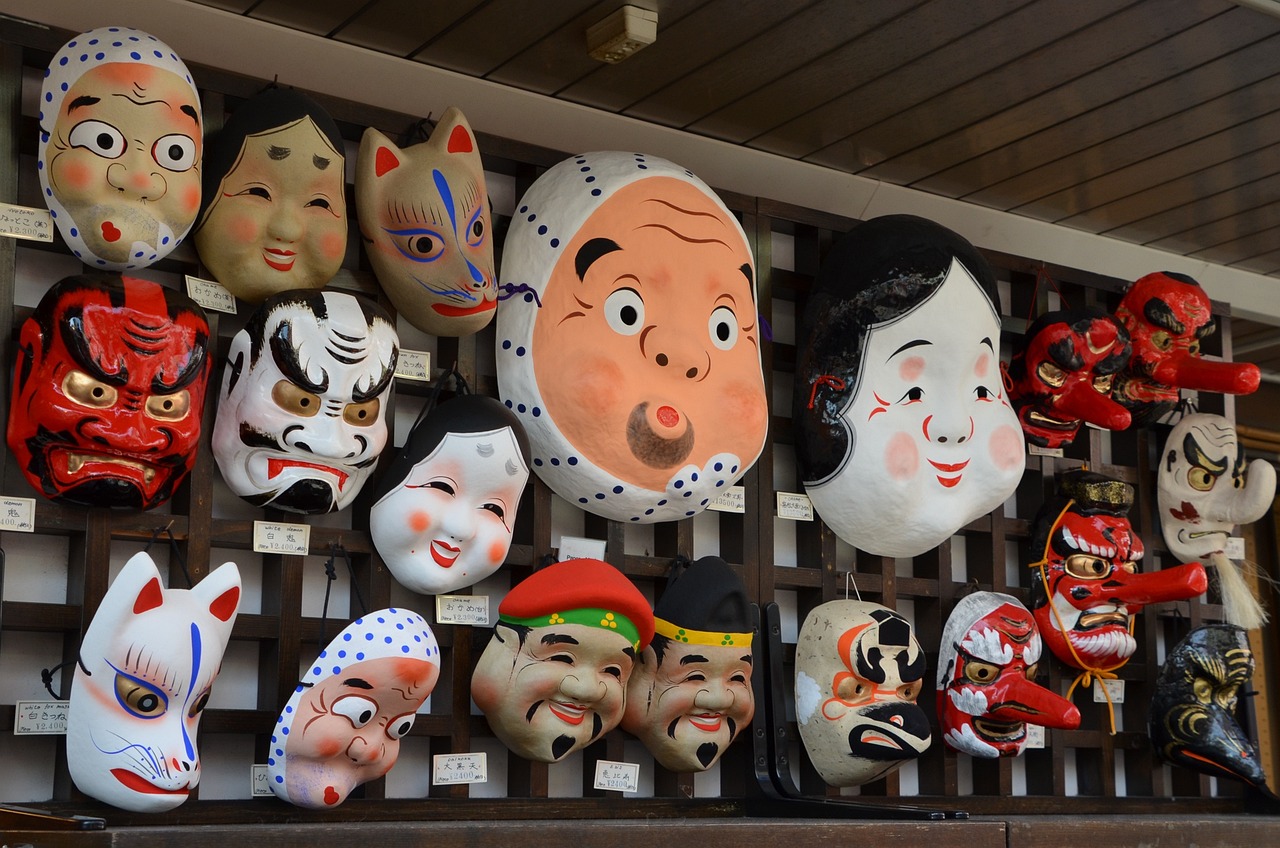 a bunch of masks hanging on a wall, by Aguri Uchida, flickr, mingei, market in japan, charming expression gesicht, japan animation, group photo