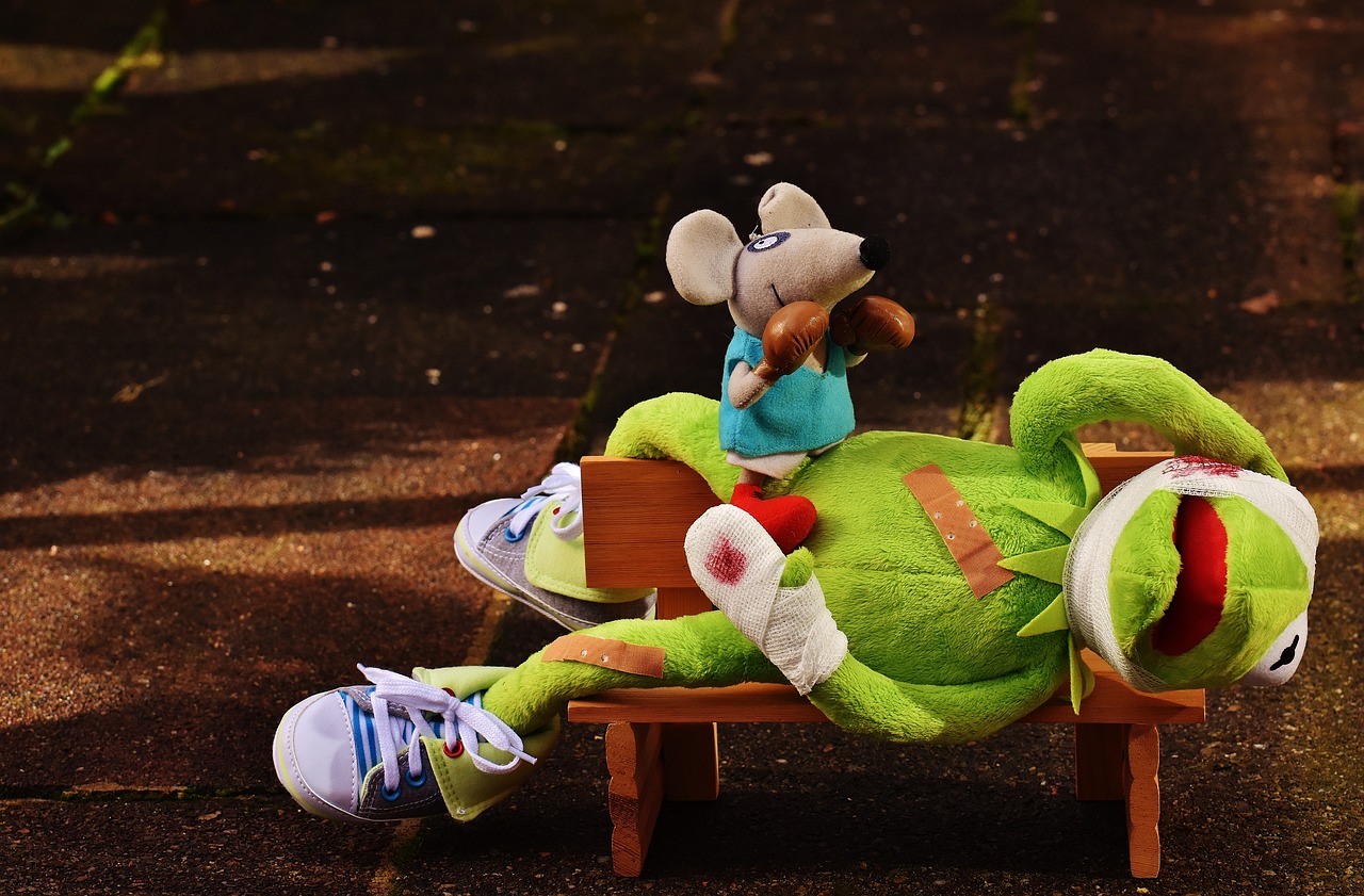 a stuffed animal sitting on top of a wooden bench, a picture, inspired by Luigi Kasimir, focus on sneakers only, ratfink, resting after a hard fight, anthropomorphic mouse