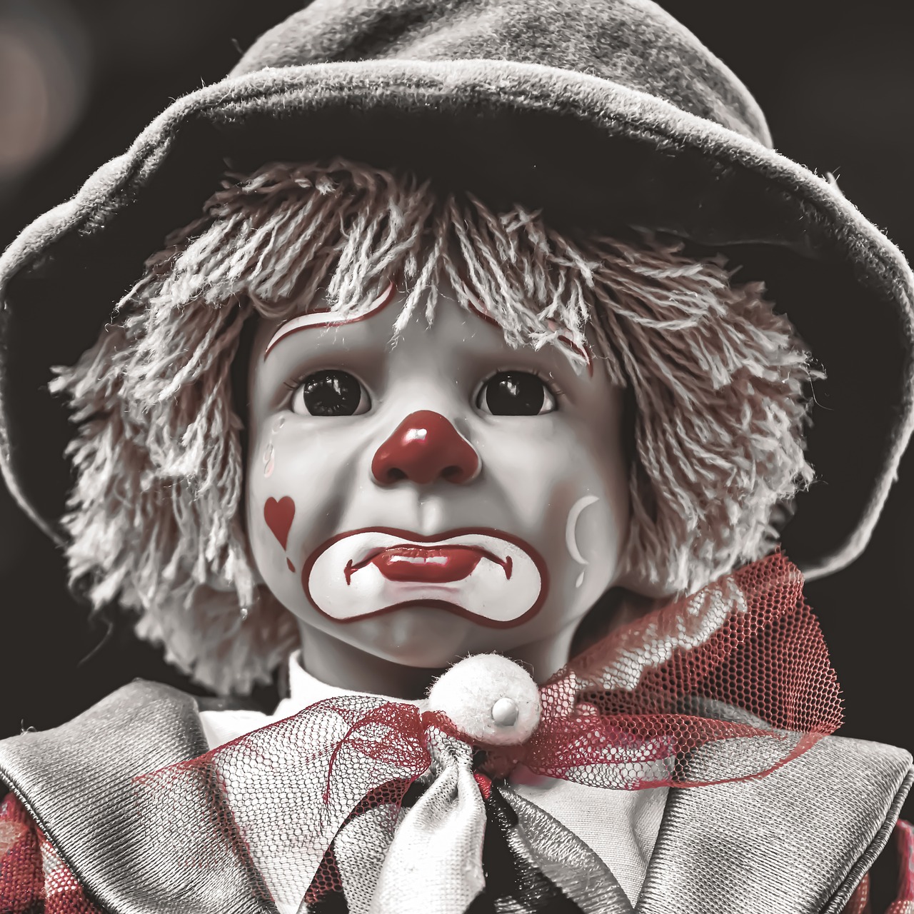 a black and white photo of a clown doll, a portrait, by Edward Corbett, trending on pixabay, coloured, hurt, closeup of an adorable, realistic image