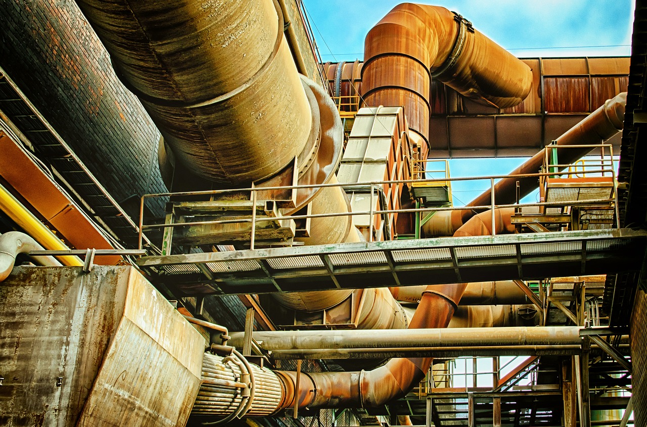 a bunch of pipes that are inside of a building, a stock photo, shutterstock, renaissance, steel mill, vibrant nature, cinematic view from lower angle, ((rust))