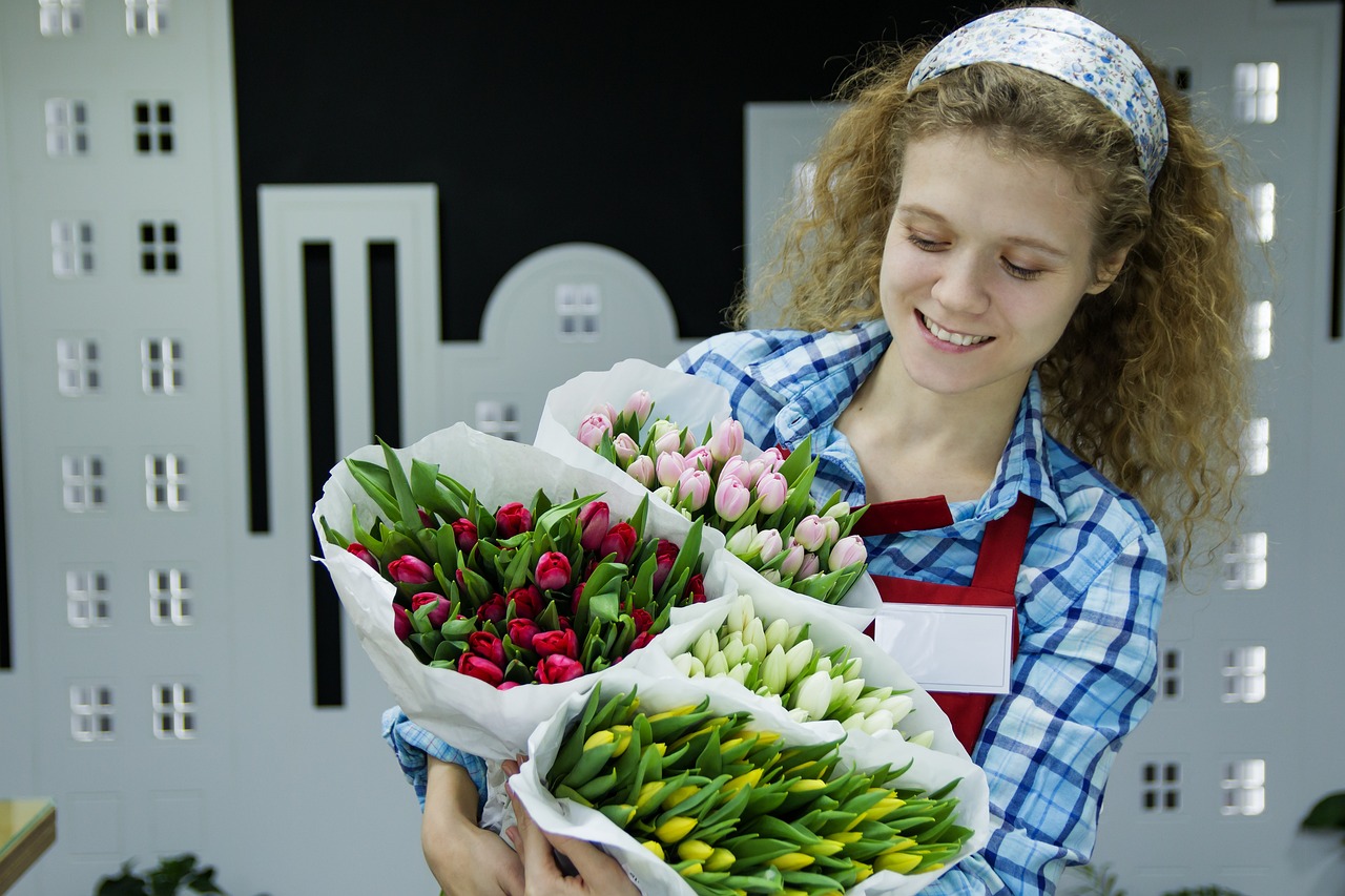 a woman holding a bunch of flowers in her hands, a picture, shutterstock, roses and tulips, ukrainian girl, flower shop scene, 4 0 0 mm