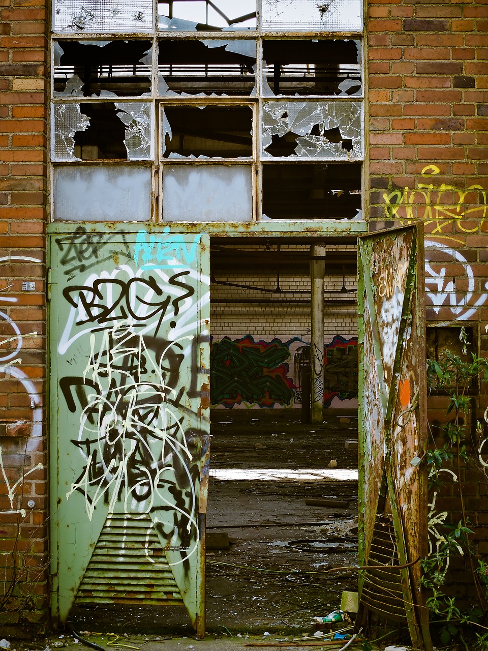 a door that has some graffiti on it, by Lee Loughridge, flickr, abandoned factory, 2 4 mm iso 8 0 0 color, caulfield, mossy ruins