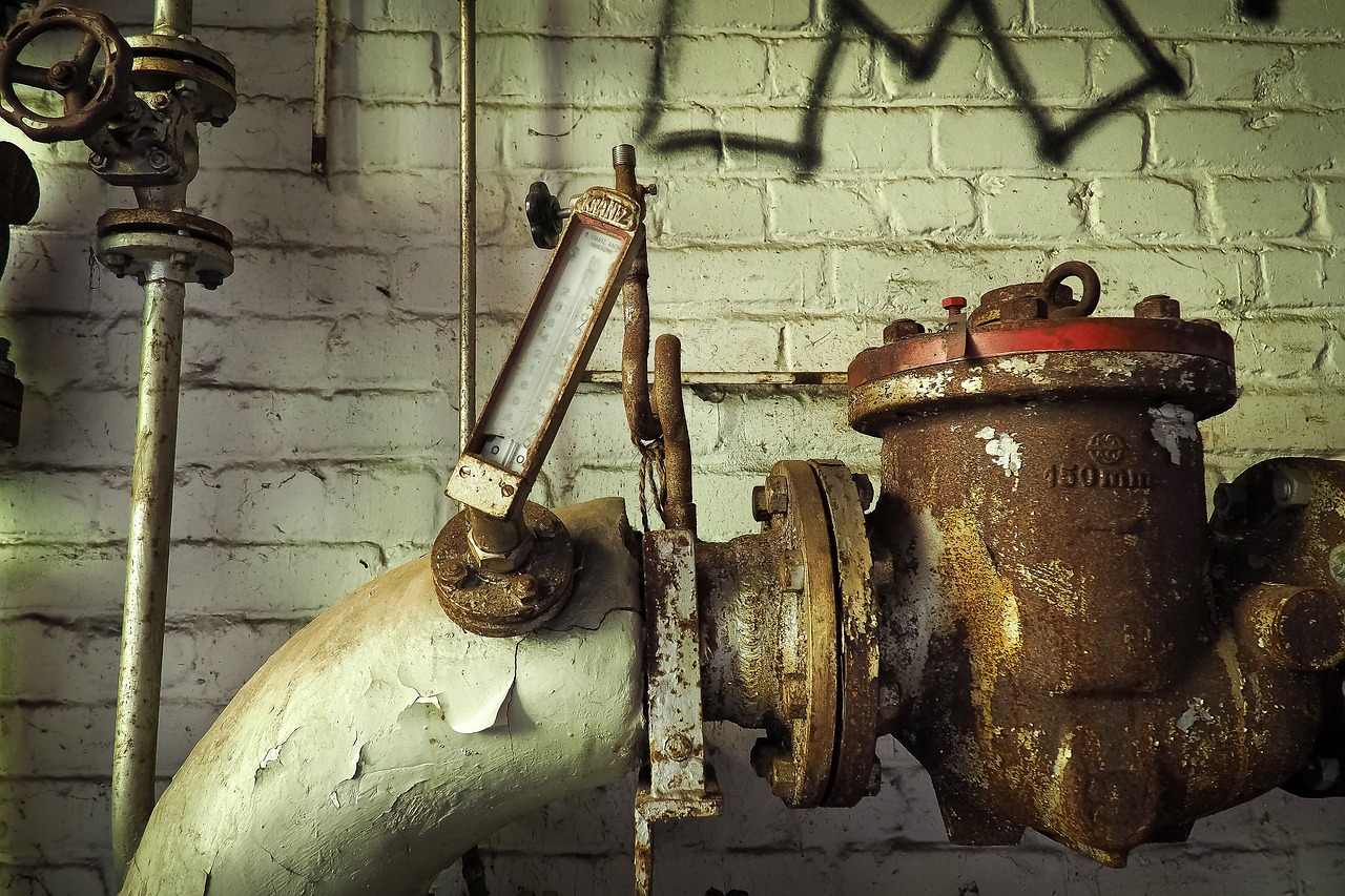 a close up of a fire hydrant near a brick wall, a picture, by Carl Rahl, pexels, assemblage, inside a decayed operating room, tubes and gauges, white machinery, hdr photo