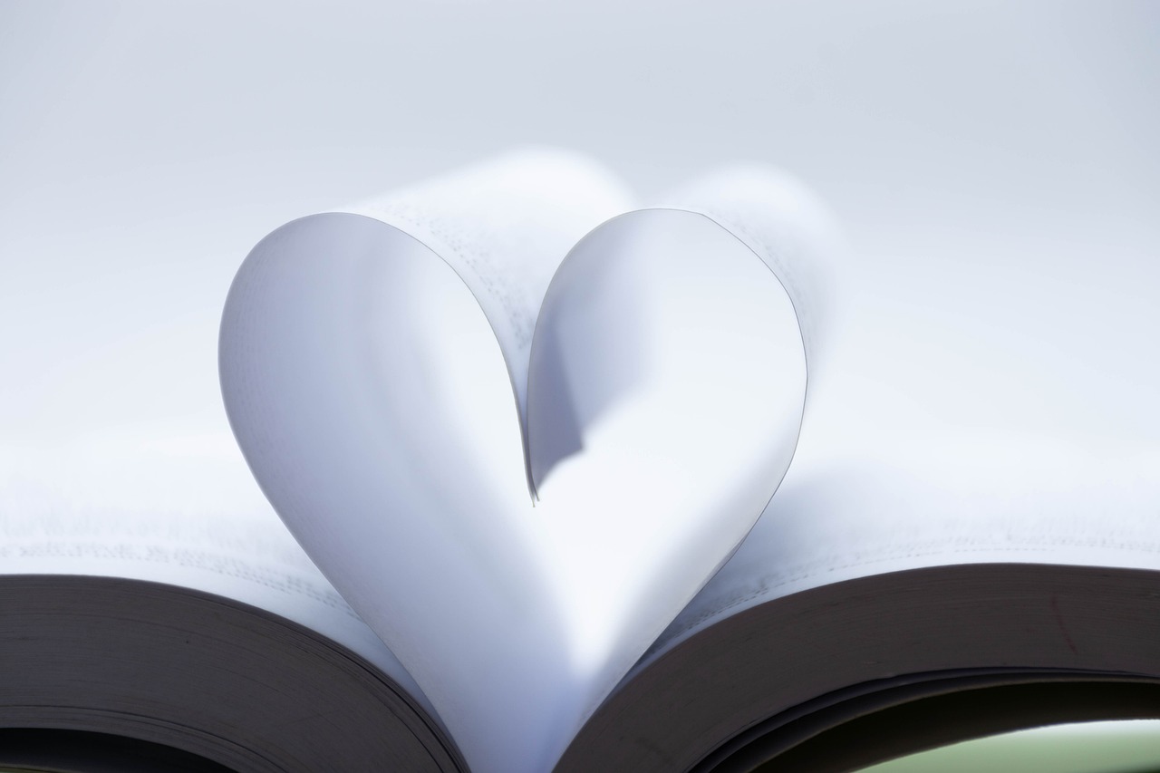 a book with a heart cut out of it, a picture, romanticism, shot from below, high res photo, dynamic closeup, clean and pristine design