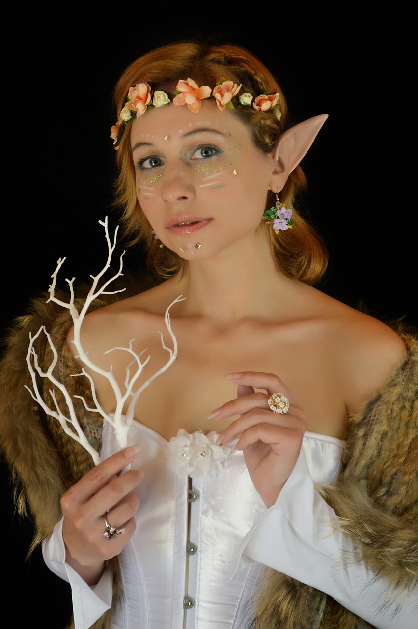 a woman dressed as a elf holding a branch, a character portrait, inspired by Elmyr de Hory, flickr, fantasy art, white powder makeup, furnished with fairy furniture, of an elden ring elf, photo of a hand jewellery model