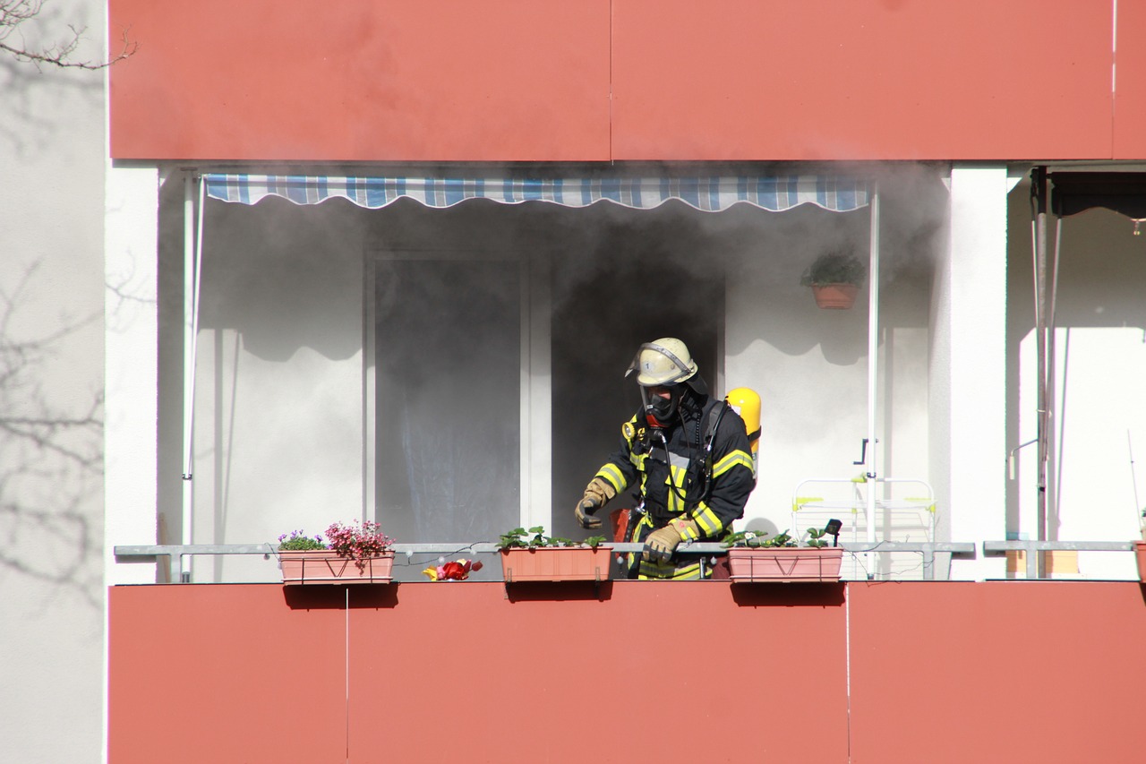 a firefighter standing on the balcony of a building, a photo, figuration libre, 2 0 1 0 photo