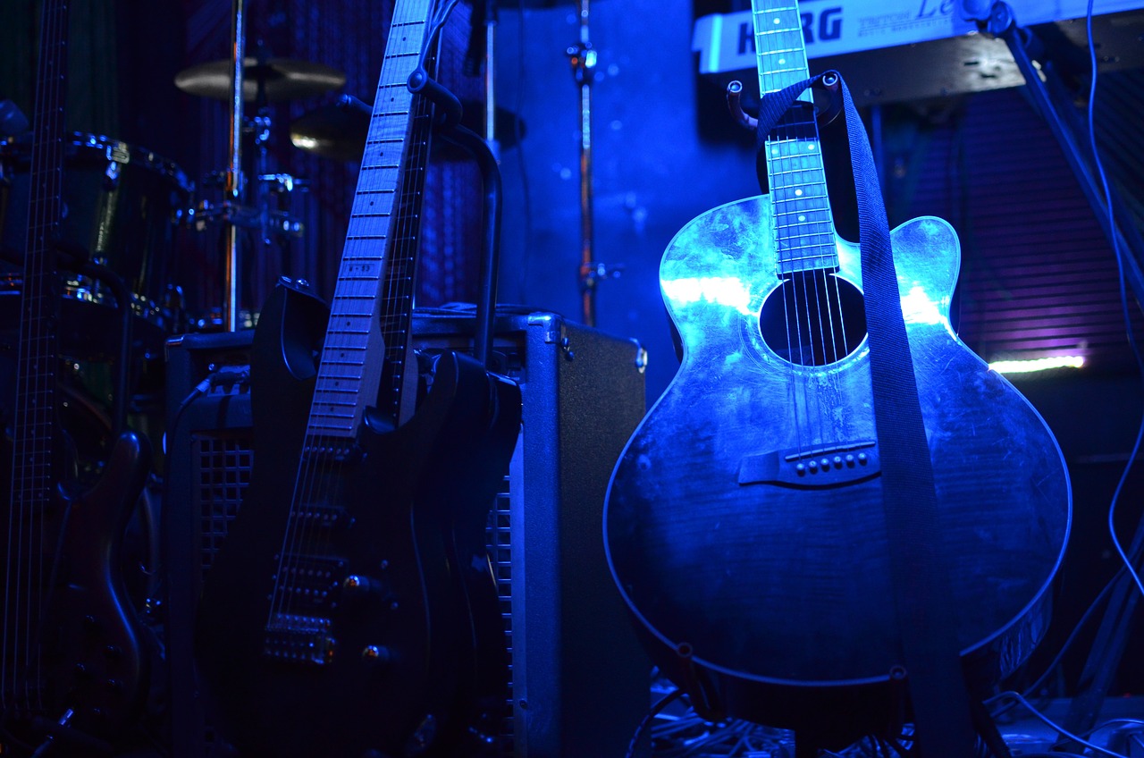 a close up of a guitar in a room, a picture, by Tom Carapic, blue shiny lighting, stage at a club, 15081959 21121991 01012000 4k, sirius a and sirius b