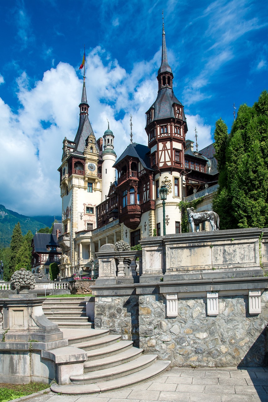 a large castle sitting on top of a lush green hillside, a photo, shutterstock, art nouveau, elaborate carved wood balconies, romanian, stepping on towers, tourist photo