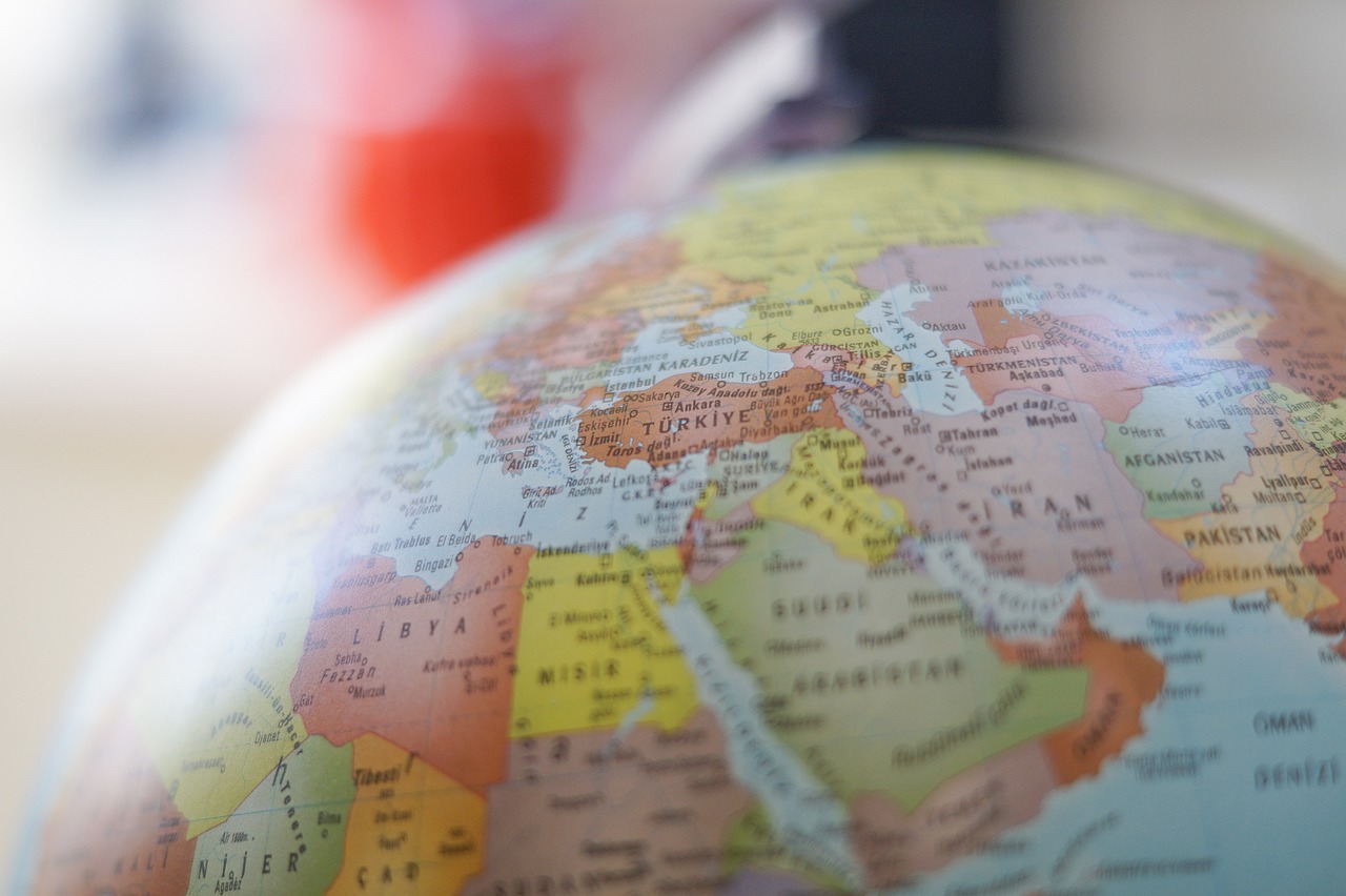 a close up of a globe on a table, a tilt shift photo, by Jakob Gauermann, shutterstock, middle eastern skin, back towards camera, from egypt, stock photo