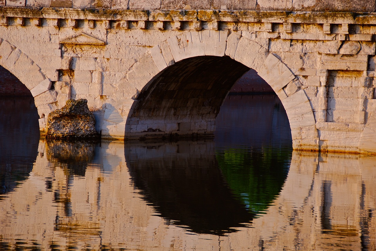 a stone bridge over a body of water, by Jan Rustem, shutterstock, romanticism, marble hole, roma, surface reflections, stock photo