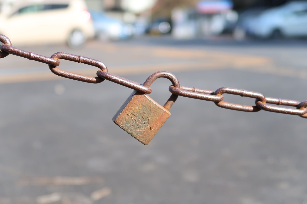 a close up of a chain with a padlock on it, auto-destructive art, street corner, 7 0 mm photo