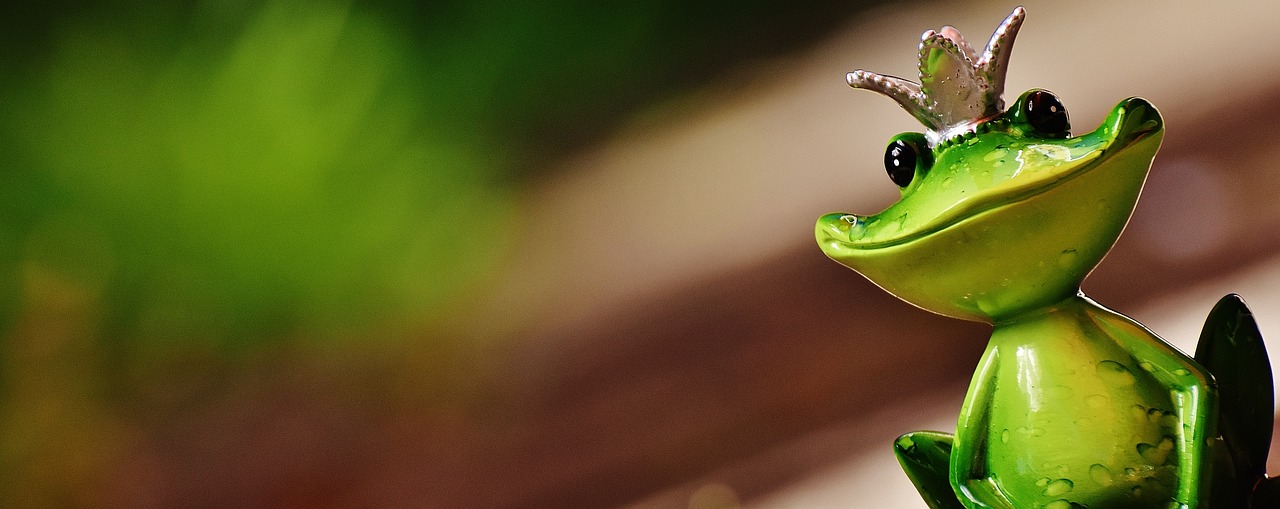 a figurine of a frog with a crown on its head, a macro photograph, by Matthias Weischer, pexels contest winner, banner, green snakes, mantis, shot with a canon 20mm lens