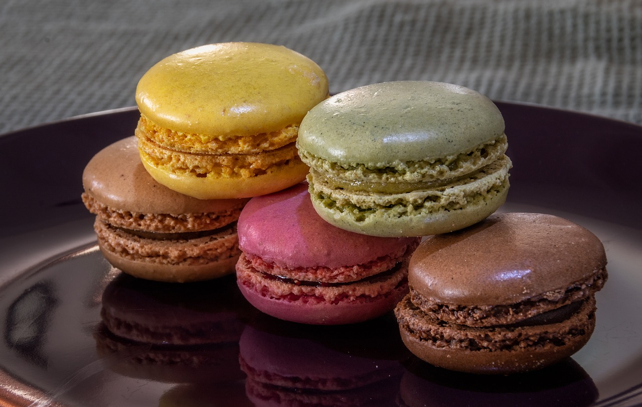a close up of a plate of macarons on a table, inspired by François Louis Thomas Francia, paul barson, highly detailed and colored, mcdonald, glazed