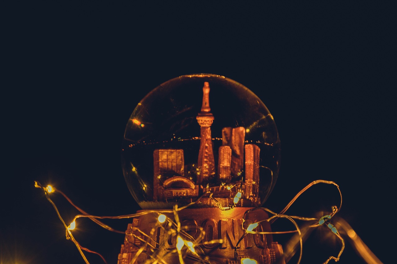 a close up of a light bulb with a city in the background, a tilt shift photo, unsplash contest winner, magical realism, in a japanese town at night, snowglobe, disco ball, shrines