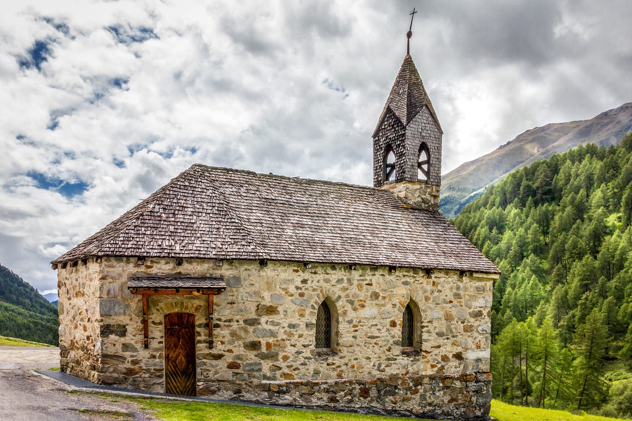 a stone church with a steeple and a clock tower, by Franz Hegi, pexels, romanesque, chalet, valle dei templi, holy ceremony, pierre puvis de chavannesa