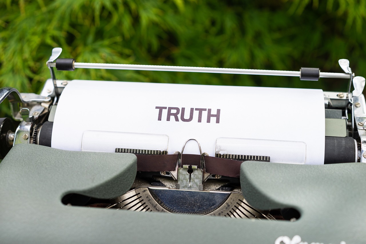 a typewriter with the word truth written on it, lying on an empty, manifestation, truth, sustainable