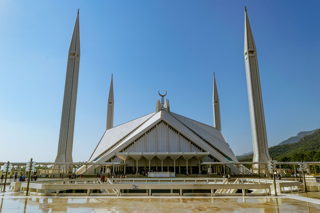a large white building with a lot of spires, a picture, by John Murdoch, shutterstock, modernism, islamic architecture, star roof, a long-shot from front, 7 0 s