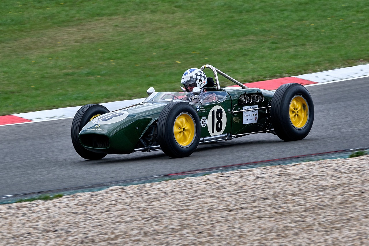 a man driving a green race car on a track, a portrait, by Peter Wells, flickr, glass and metal : : peugot onyx, lotus, pretty face!!, vintage - w 1 0 2 4