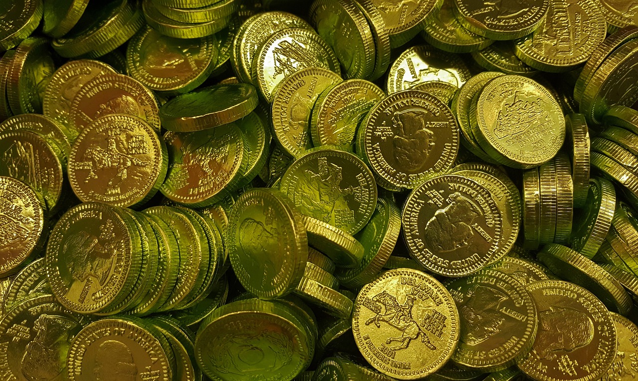 a pile of gold coins sitting on top of each other, a stock photo, pixabay, gold green creature, chocolate, taken from the high street, | 35mm|