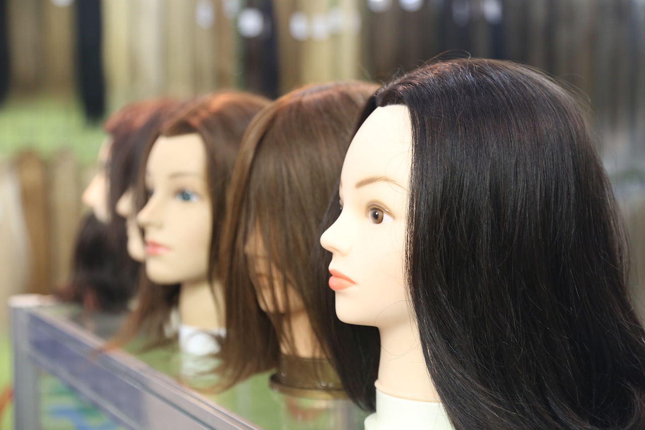 a row of mannequin heads in front of a mirror, realism, female with long black hair, product introduction photo, closeup photo, cut