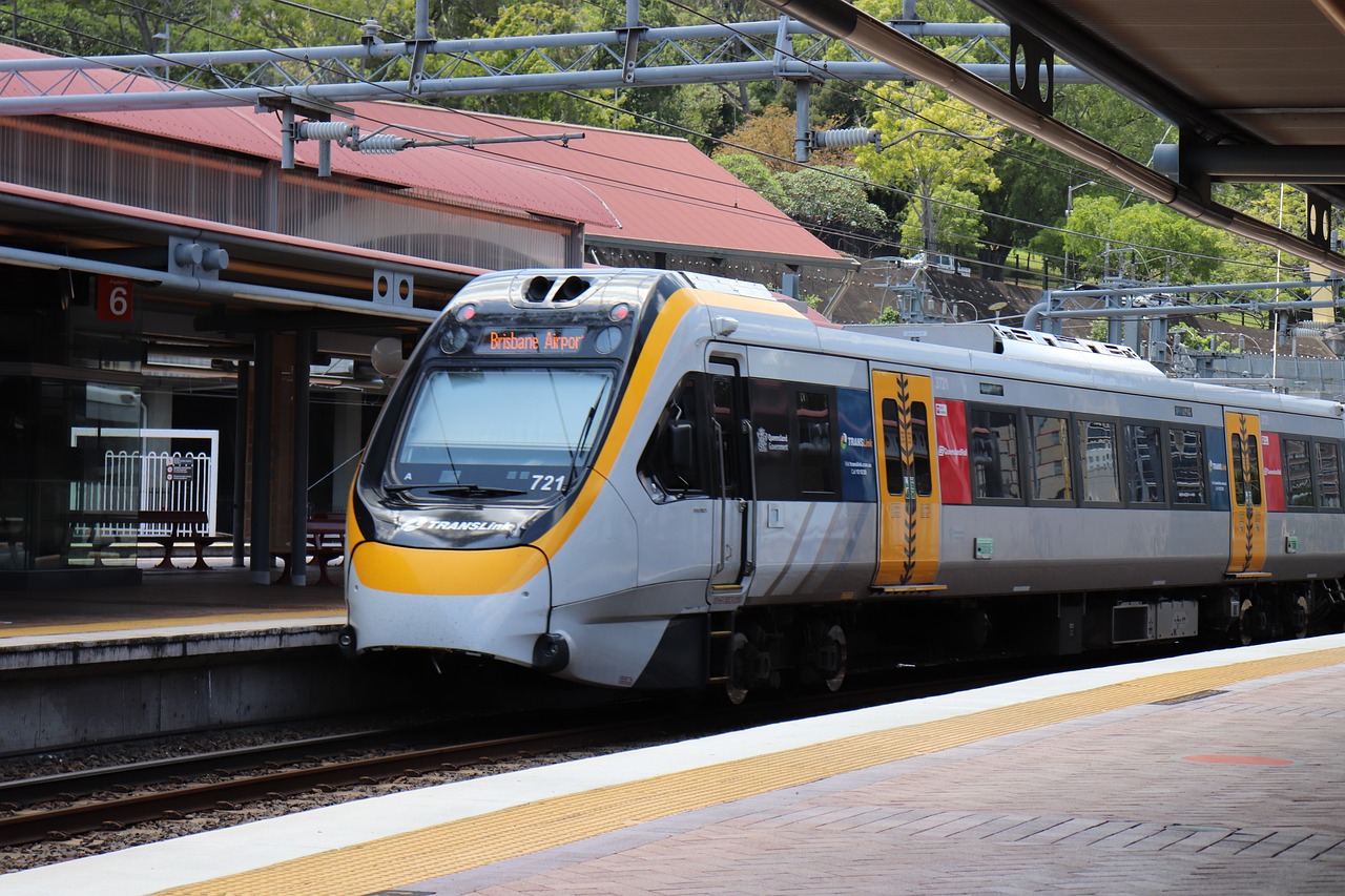 a silver and yellow train pulling into a train station, by Tom Scott RSA, shutterstock, tamborine, screengrab, manuka, fully covered