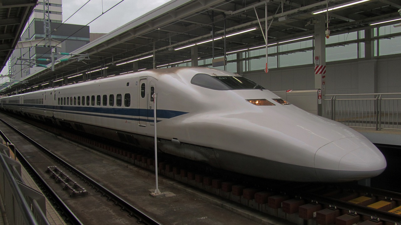a white bullet train pulling into a train station, by Yasushi Sugiyama, flickr, very slightly smiling, huge gargantuan scale, on display, detailed zoom photo