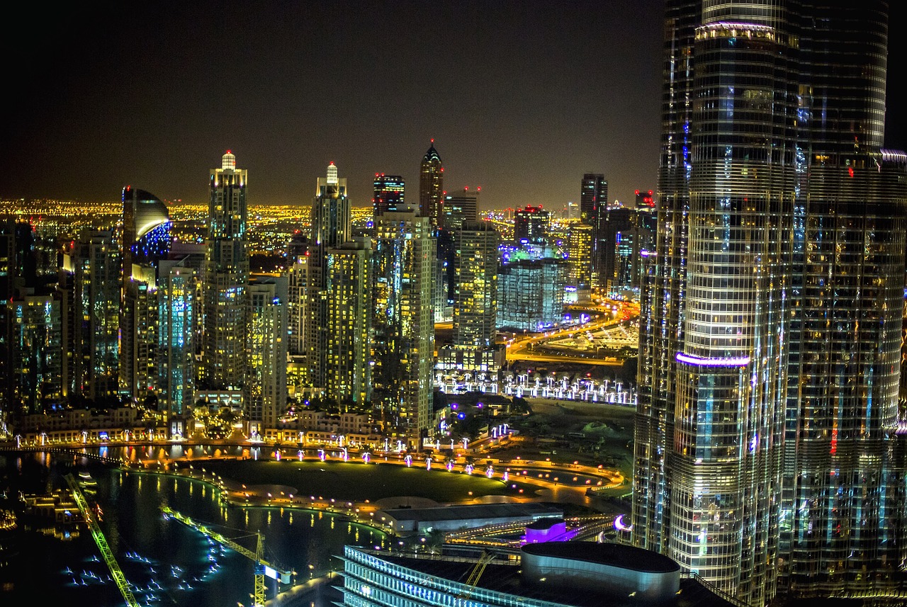 an aerial view of a city at night, by Alexander Robertson, pexels contest winner, sheikh mohammed ruler of dubai, hdr photo, highly detailed!, finer details : 3