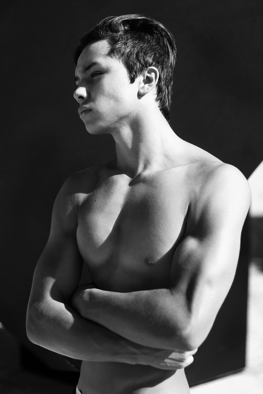 a black and white photo of a shirtless man, a black and white photo, inspired by Anthony Devas, jimin\'s grecian nose, woo kim, perfect crisp sunlight, tommy 1 6 years old