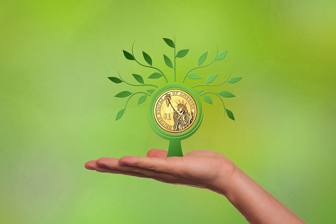 a hand holding a coin with a tree growing out of it, a digital rendering, art nouveau, green energy, gold plated, clean photo, with 3d render