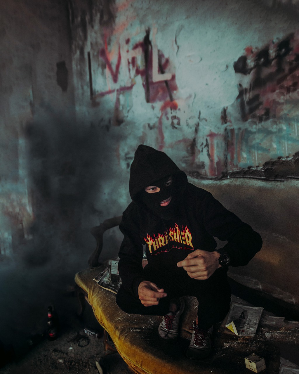 a man in a black hoodie sitting on a surfboard, a portrait, tumblr, graffiti, tactical team in hell, 🕹️ 😎 🔫 🤖 🚬, fiery atmosphere, hasselblade shot