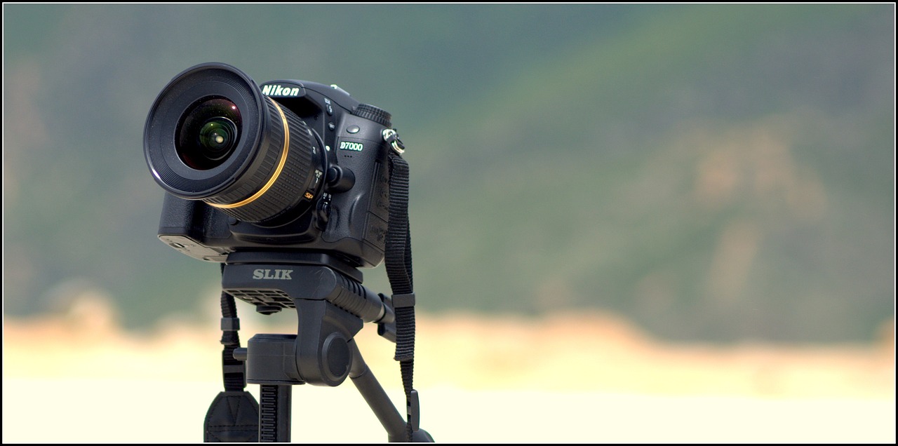 a close up of a camera on a tripod, a tilt shift photo, by Mathias Kollros, hdr!, panoramic photography, nikkor, video camera