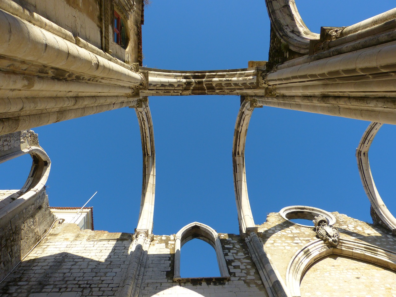 a very tall building with a blue sky in the background, a picture, flickr, romanesque, inside the ruined gothic church, lisbon, upsidedown, arcs