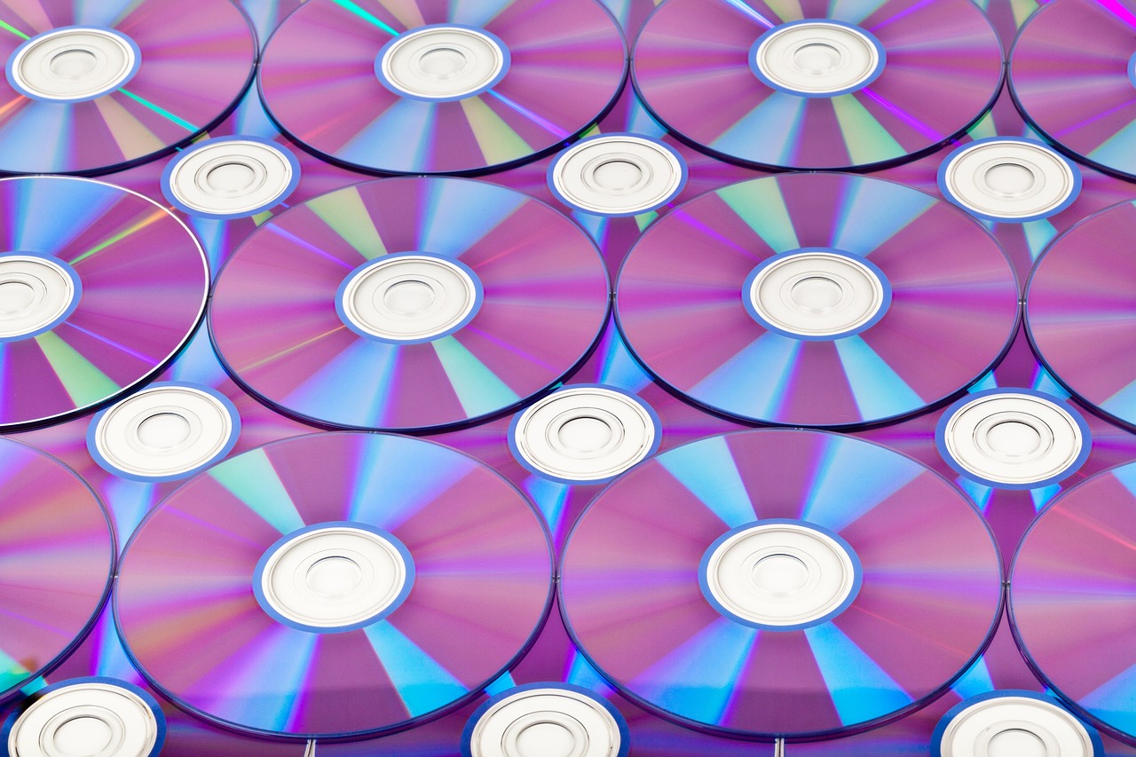 a bunch of cds stacked on top of each other, a stock photo, shutterstock, computer art, multiple purple halos, modern high sharpness photo, colorful computer screen, big production