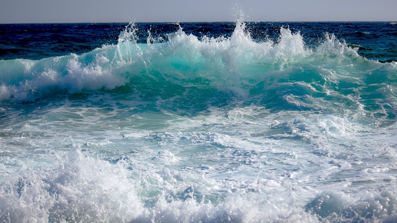 a person riding a surfboard on a wave in the ocean, a picture, azure waves of water, glistening seafoam, shockwaves are coming out, scylla and charybdis