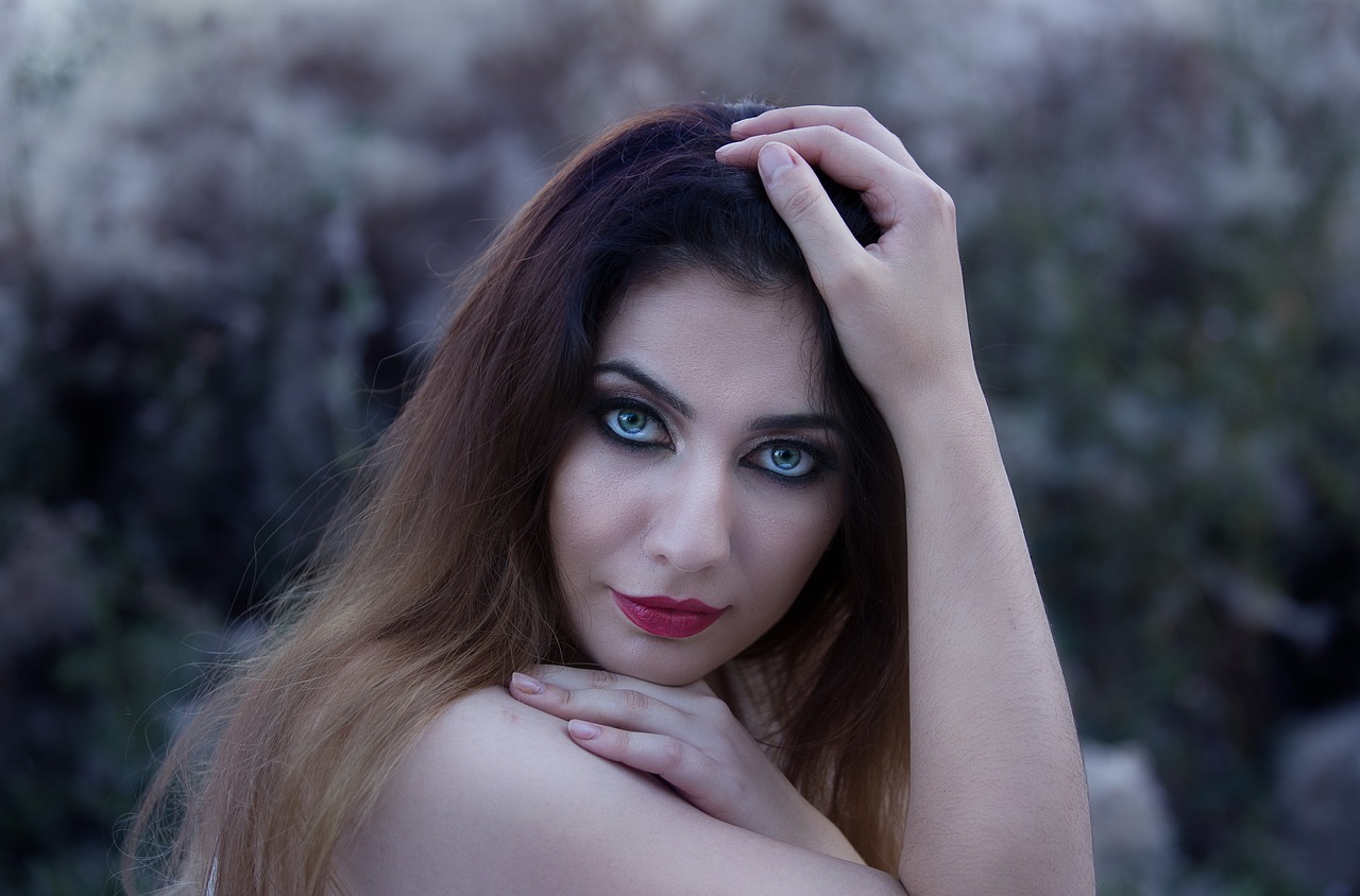 a woman with blue eyes posing for a picture, inspired by irakli nadar, art photography, greek ameera al taweel, beautiful female vampire, taken with canon eos 5 d mark iv, hands in her hair