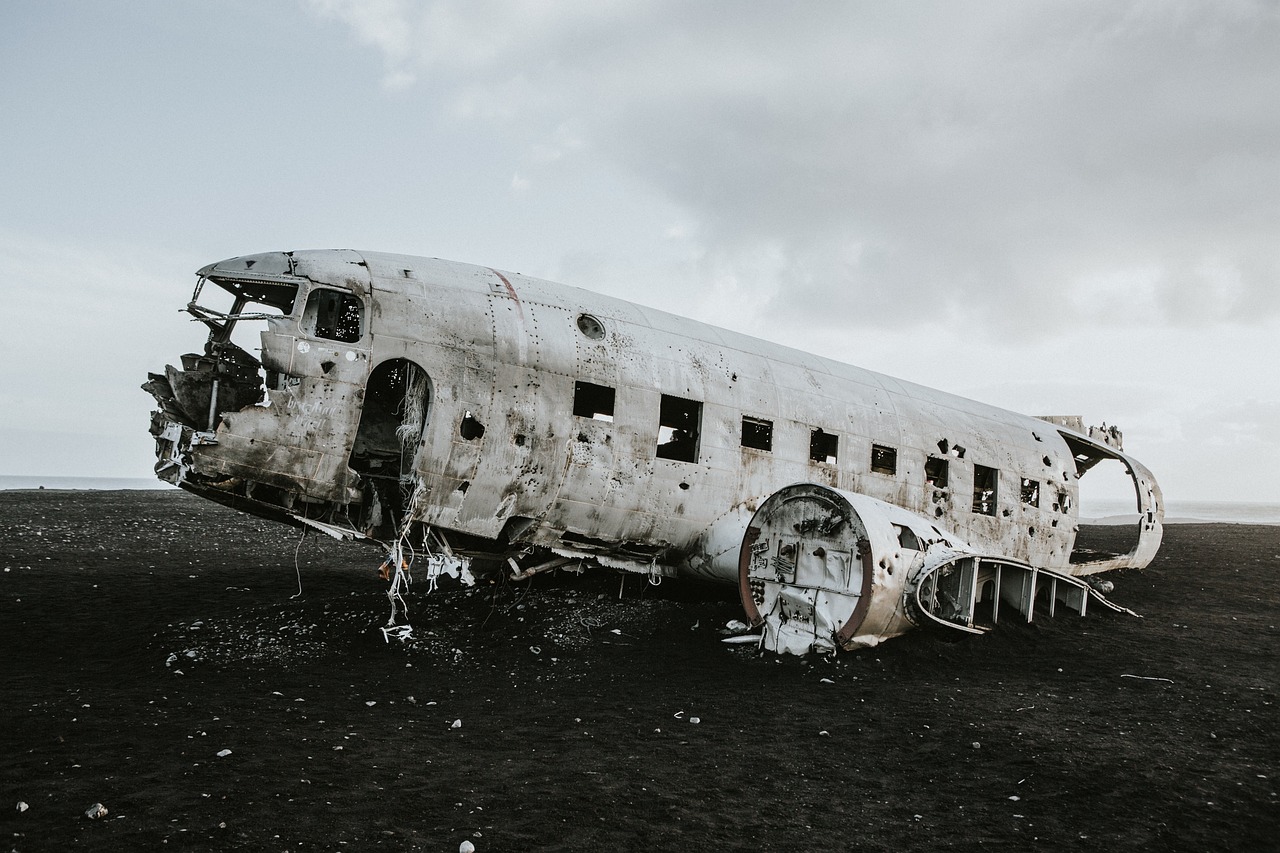 an old airplane sitting in the middle of a field, unsplash contest winner, destroyed body, reykjavik, gray wasteland, front profile shot