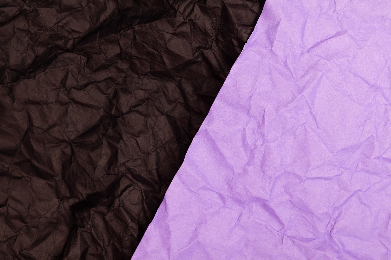a purple and black piece of paper next to each other, shutterstock, paper crumpled texture, packshot, background image, two colors