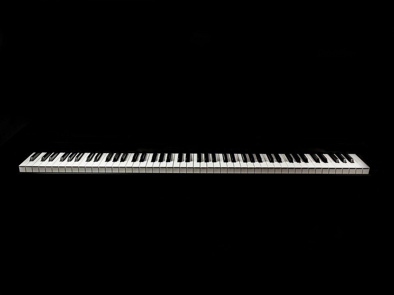 a close up of a keyboard on a black background, an album cover, minimalism, super long shot, miniature product photo, isolated, very accurate photo