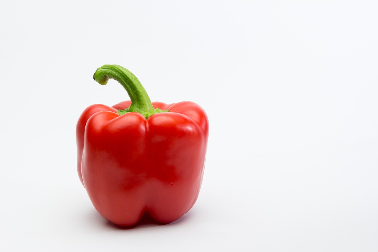 a red bell pepper on a white background, by Juan O'Gorman, “organic, where a large