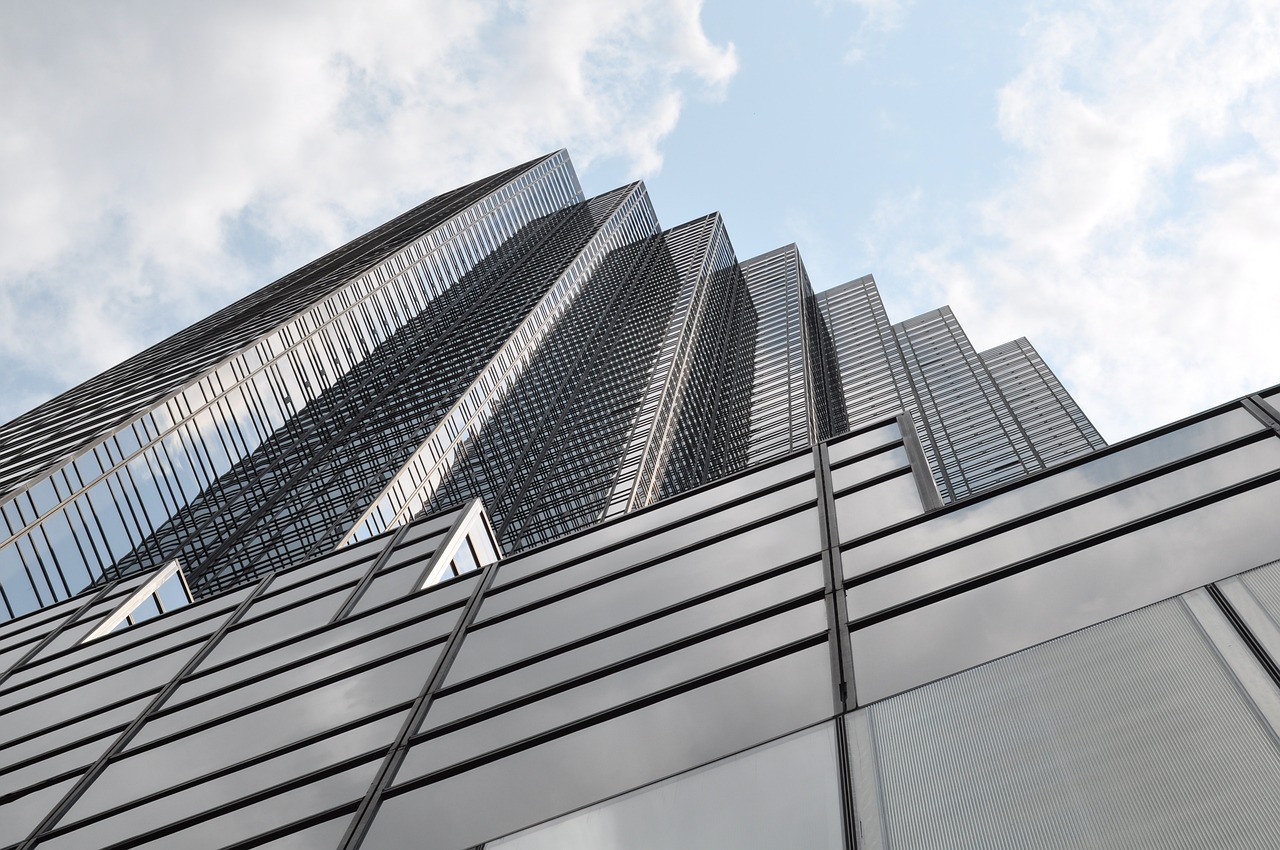 a very tall building with lots of windows, inspired by David Chipperfield, flickr, dynamic low angle shot, with shiny glass buildings, high detail photo, tokujin yoshioka