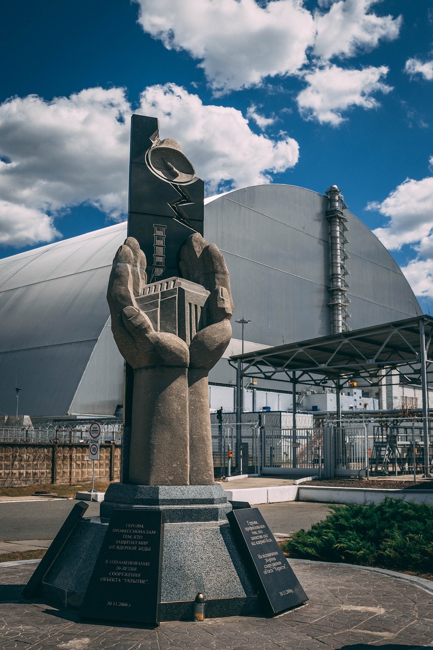 a statue in front of a building with a sky background, nuclear art, reactor, closed hands, photo of the year 2 0 2 2, flasks in hands