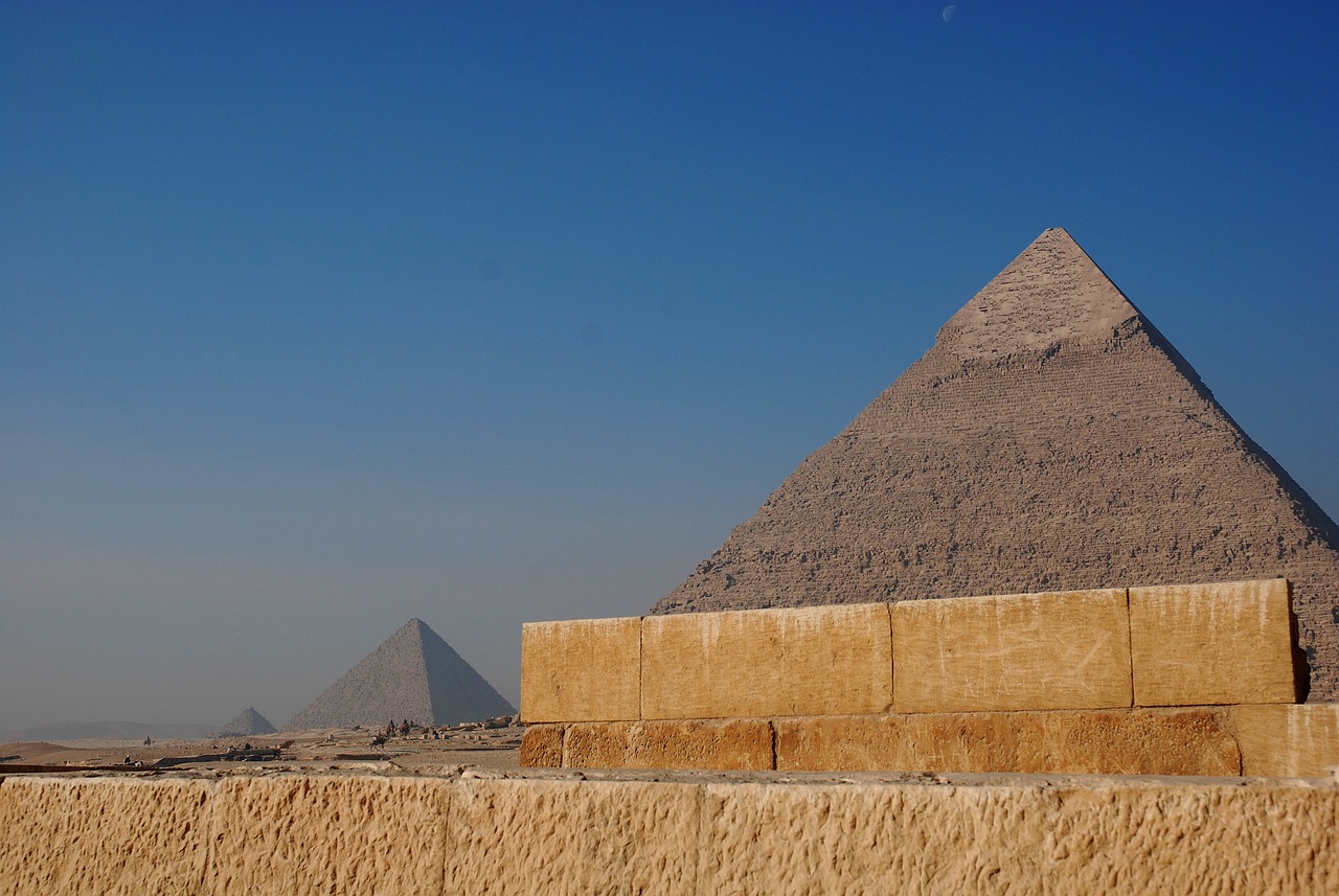 a group of people standing in front of a pyramid, egyptian art, by Dietmar Damerau, flickr, two giant towers, view from the side”, concrete, seen from earth