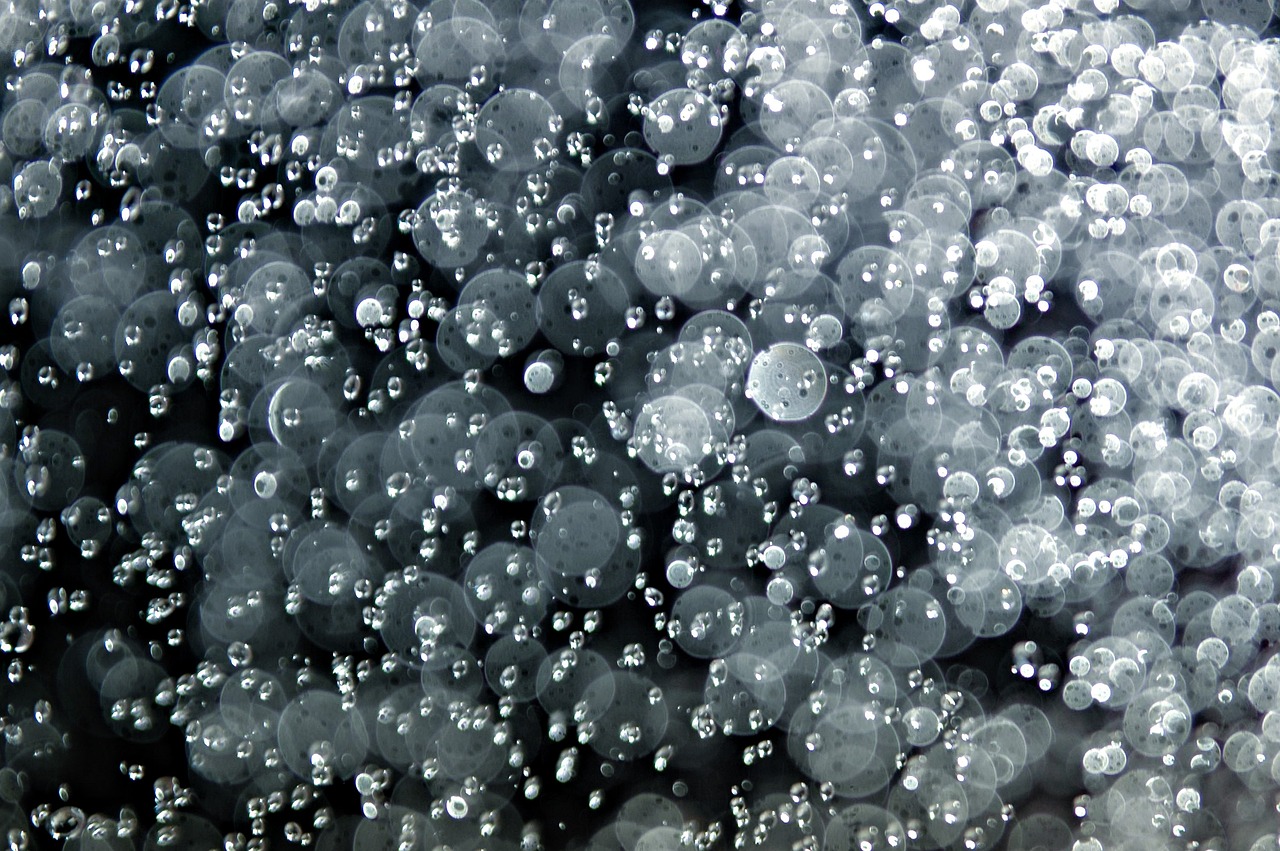 a close up of a bunch of water droplets, flickr, pointillism, bubble goth, sea of milk, background ( dark _ smokiness ), soap bubbles