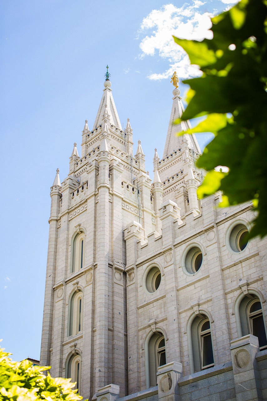 a large white building with a clock on top of it, by Jaime Colson, tall spires, divine details, utah, summer light