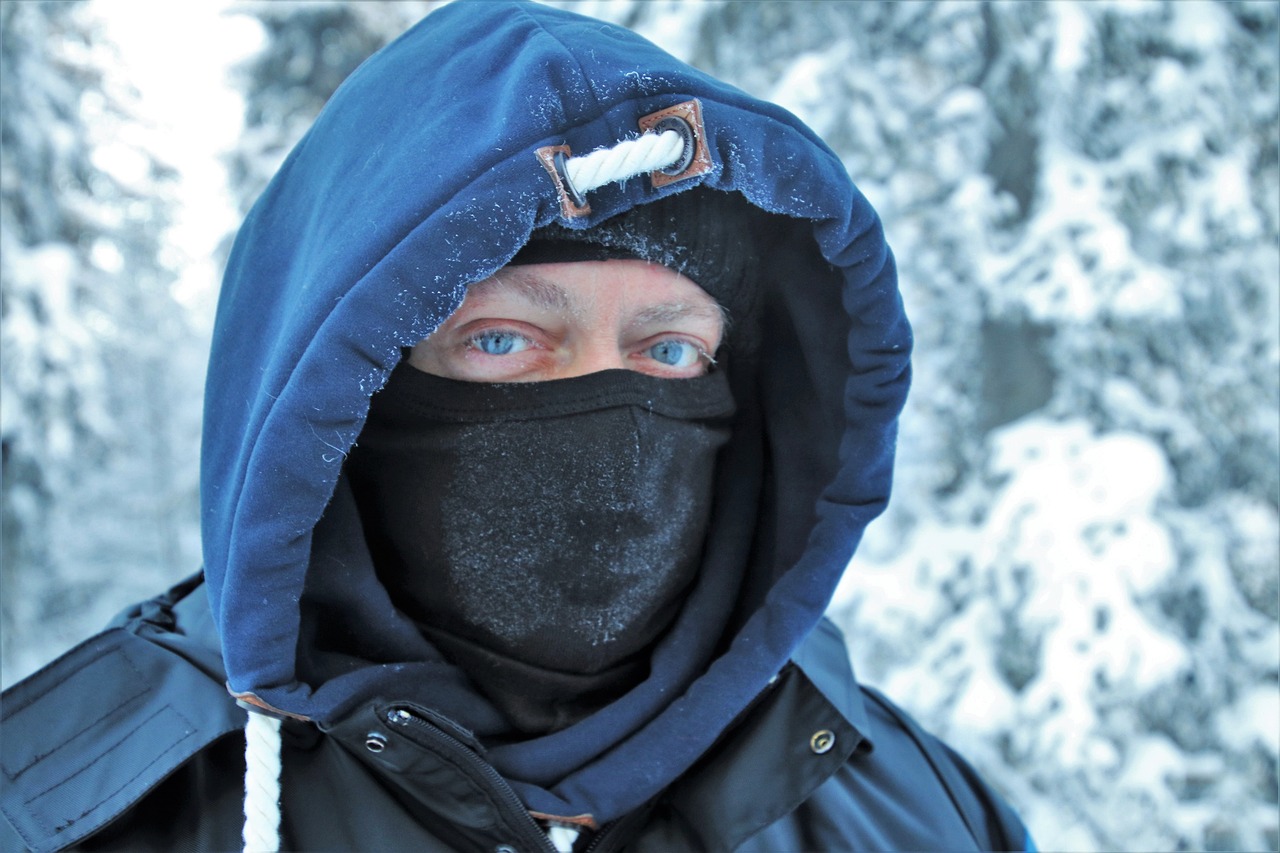 a man wearing a face mask in the snow, a photo, by Veikko Törmänen, realism, in a hood, closeup portrait, covered!, portrait of a male hydromancer
