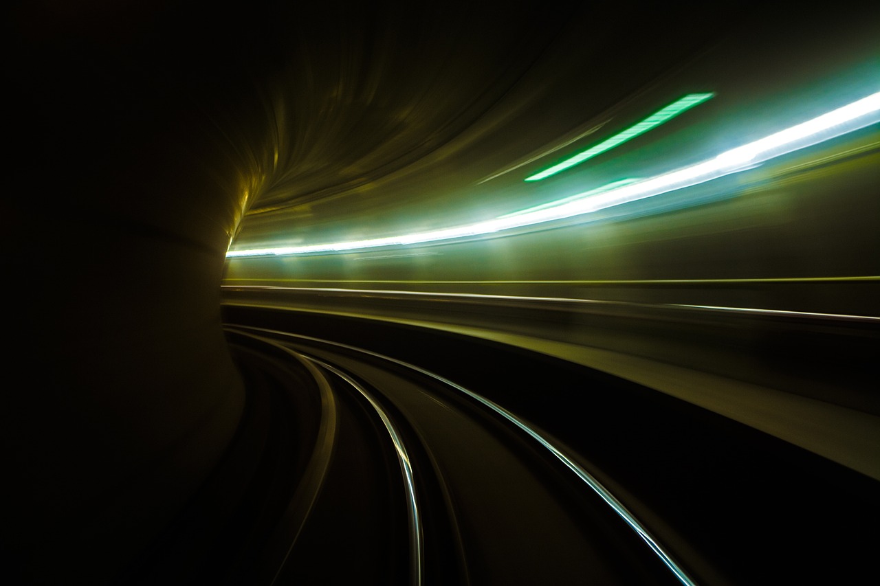 a train traveling through a tunnel at night, a picture, by Thomas Häfner, flickr, futurism, abstract lighting, tube wave, set photo, istockphoto