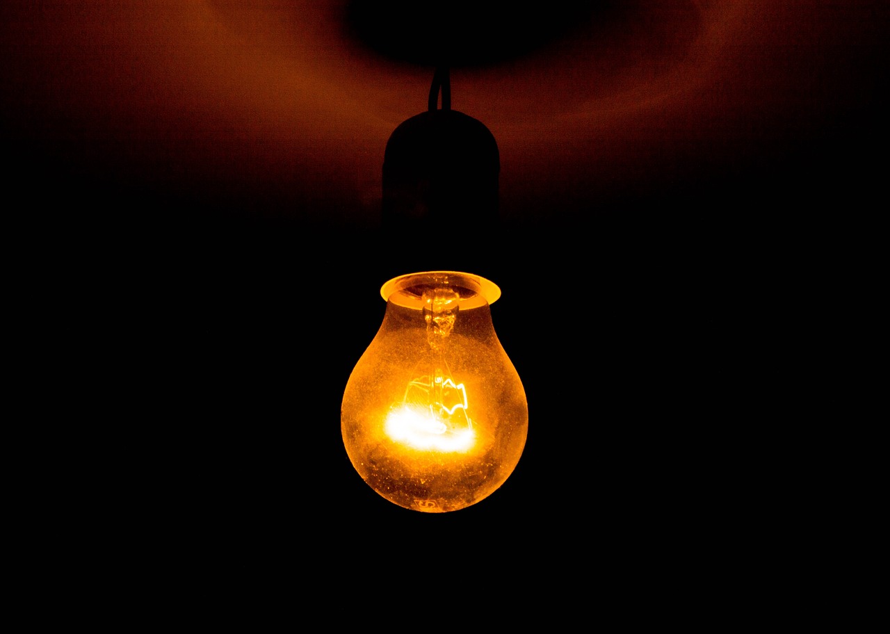 a light bulb that is glowing in the dark, a picture, by Matt Stewart, electric orange glowing lights, istockphoto, gaslight, caustics lighting from above