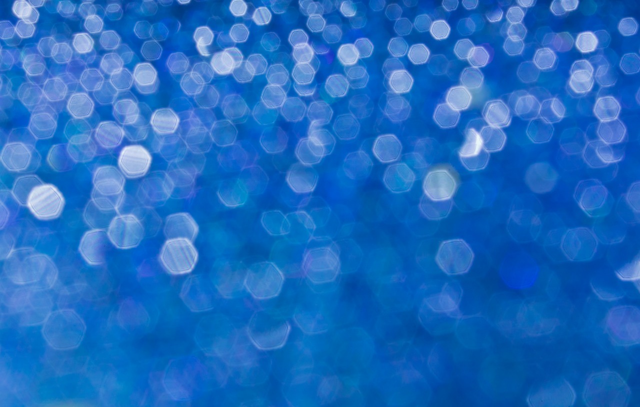 a close up of a blurry blue background, by Jan Rustem, shutterstock, pointillism, (((underwater lights))), luminous sparkling crystals, blue! and white colors, glossy reflections