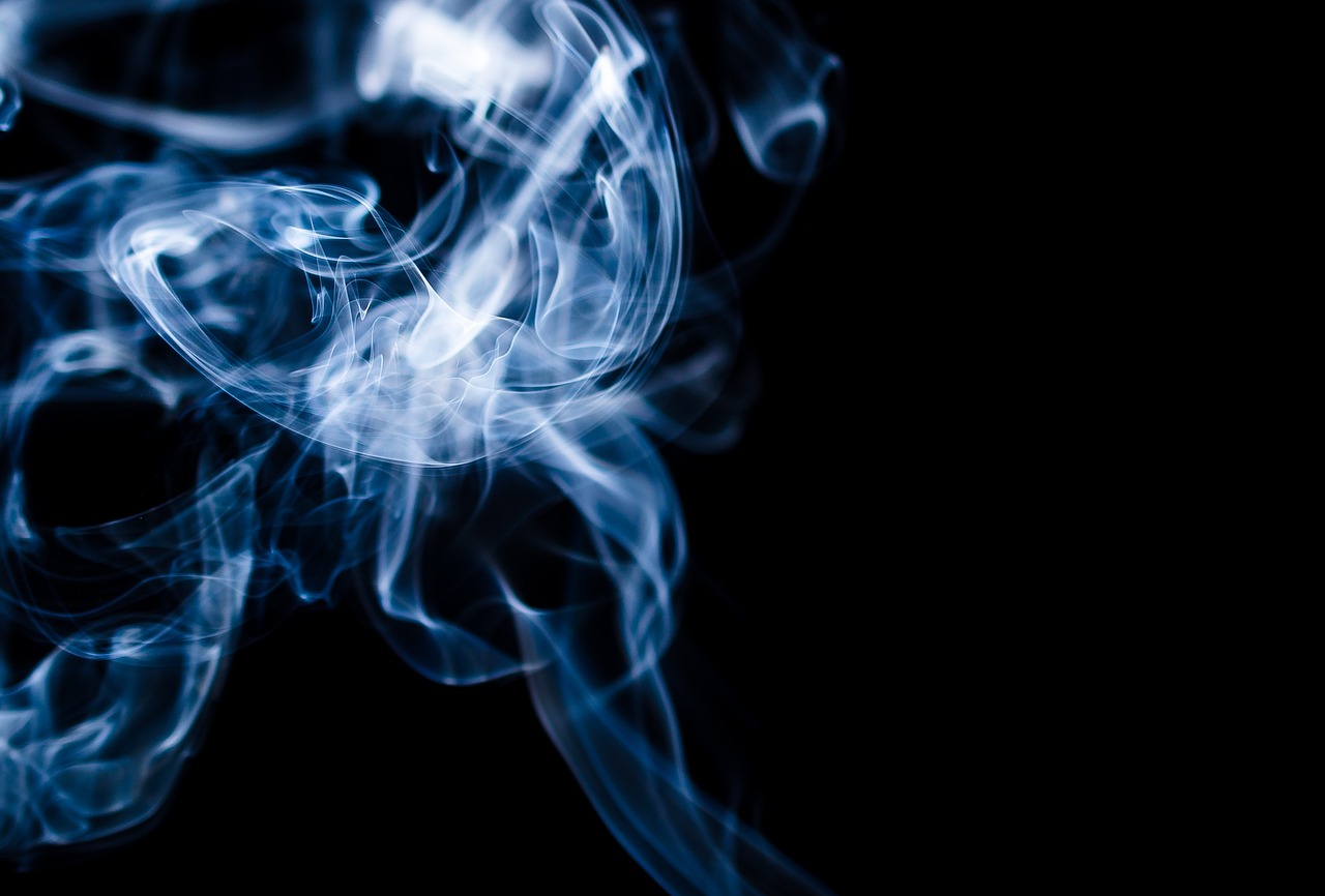 a close up of smoke on a black background, a macro photograph, shutterstock, blue haze, with dark ghost smokes around, stock photo, slow - shutter